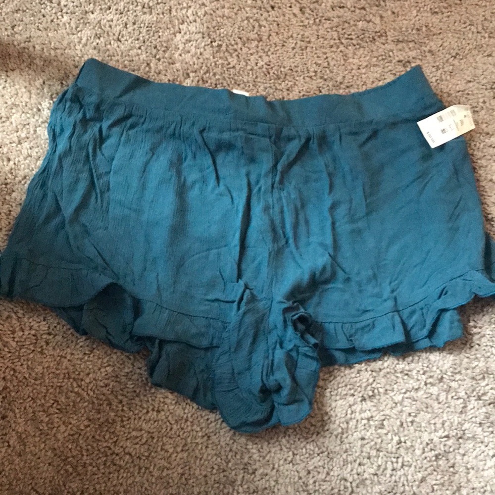 Teal flowy shorts with ruffles at the bottom